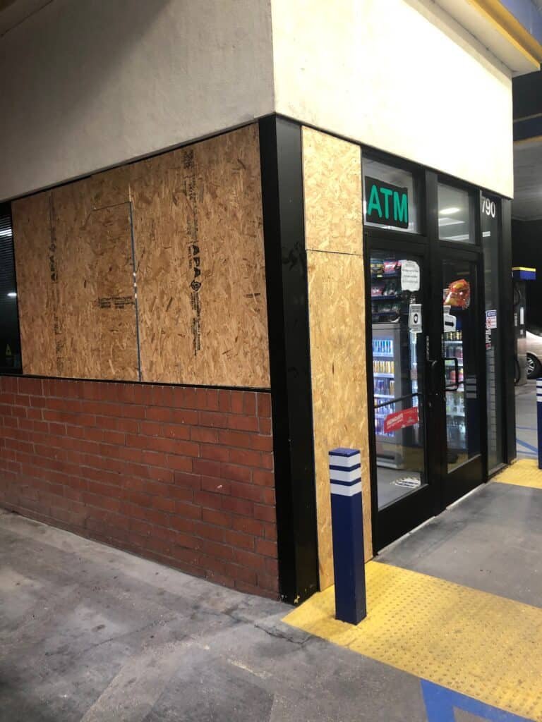 Plywood panels protecting damaged storefront openings